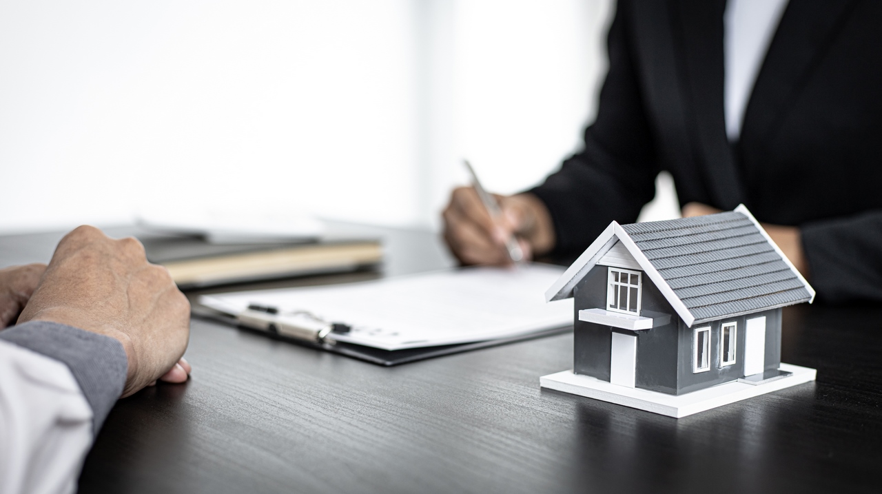 Real estate agent talked about the terms of the home purchase agreement and asked the customer to sign the documents to make the contract legally, Home sales and home insurance concept.